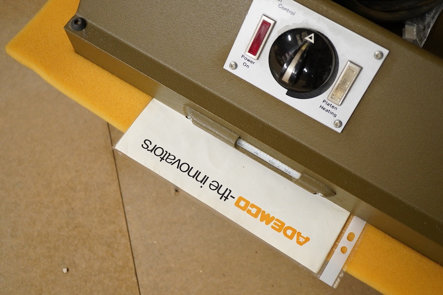 A collection of framing equipment to include Ademco heat press, C & H Bainbridge oval master mount cutter, Longridge baseboard, various mount and backing boards, tools, cutters, clamps and point drivers, many with instru